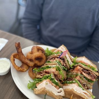American Host Restaurant - Club sandwich with onion rings and side of ranch dressing. - Diners Near Me - Lompoc, California American Host Restaurant - Club sandwich with onion rings and side of ranch dressing. - Diners Near Me - Lompoc, California