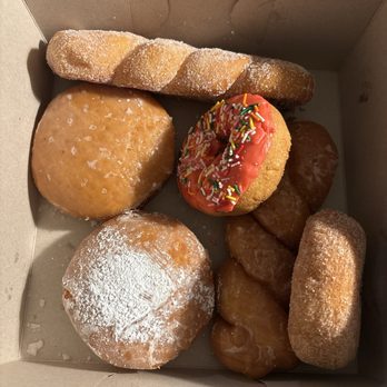 Foothill Donuts - Lemon-filled and powdered sugar covered donut. Glazed twisted donut. Sugar twist donut. Pink sprinkle donut. Sugar covered donut. - Donuts Near Me - Bakersfield, California