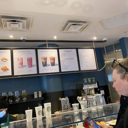 a woman ordering a drink at the counter a woman ordering a drink at the counter