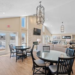 Enclave - A dining area with a glass table surrounded by chairs.