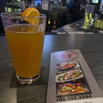 Sunset Tavern - a glass of orange juice and a menu - Sports Bars Near Me - Henderson, Nevada