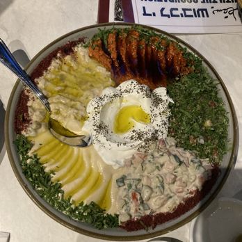 Ayat - Mezze Filistini. Clockwise - muhammarah, tabbouleh (green), salata tahina, hummus, and baba ghanoush. At center is labneh and olive oil. - Middle Eastern Near Me - New York, New York