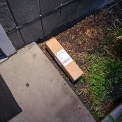 US Post Office - My package was left out in the rain and in the muddy planter on this rainy morning. Good thing I was soon there to grab it!