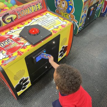 Chuck E. Cheese - a child playing a game - Pizza Near Me - Bronx, New York