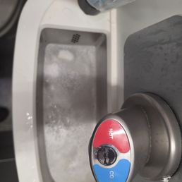 The cl9gged sink with dirty water