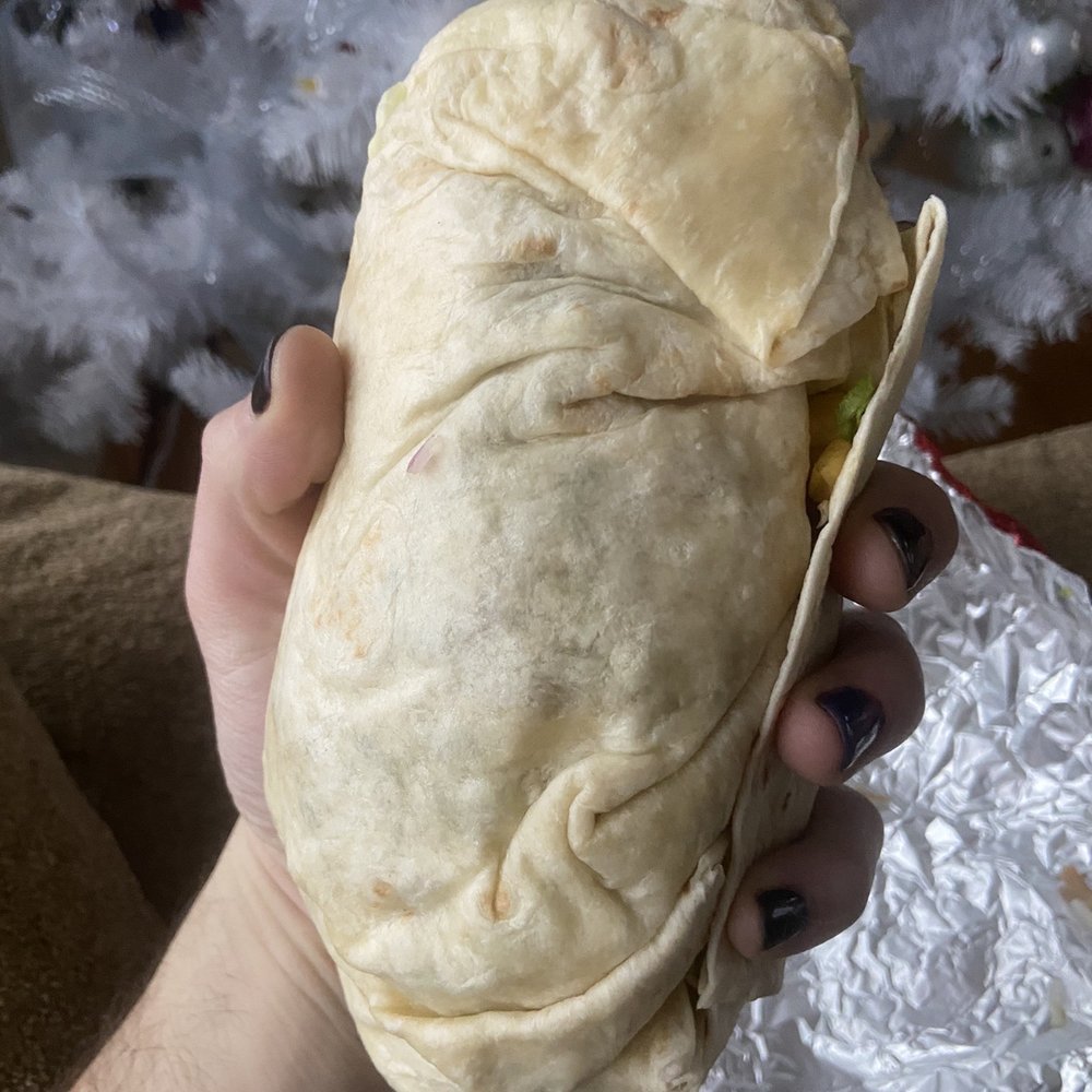 a hand holding a burrito a hand holding a burrito