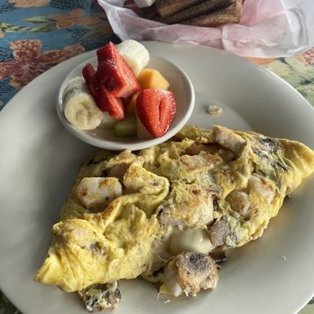 Cracked Conch Cafe - Seafood omelette with fresh fruit and wheat toast options. - Seafood Near Me - Marathon, Florida
