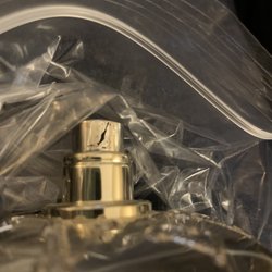 Designer Fragrances & Cosmetic Company - Cracked lid and leaking fragrance.  This is a bottle of a Versace fragrance.