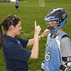 Pivot Physical Therapy - Pivot athletic trainer Katie Cicia out in the field working on concussion management with a student athlete.