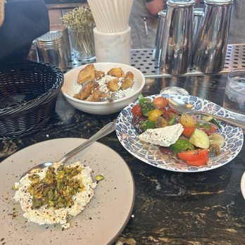 ABA - Plentiful crispy potatoes: zesty, fresh village salad, whipped feta. - Mediterranean Near Me - Nashville, Tennessee