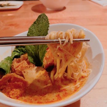 Fat Choi - a bowl of noodles and meat with chopsticks - Vegan Near Me - Toronto, Ontario