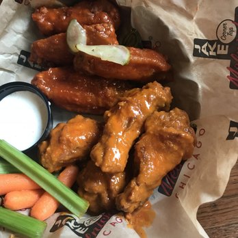 Jake Melnick's Corner Tap - Nashville Hot with pickle slices (left) and Traditional Buffalo Spicy (right). - Sports Bars Near Me - Chicago, Illinois