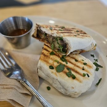 Convivio Café - Burrito with red sauce on the side. Sauce is chipotle flavored. - Coffee & Tea Near Me - Denver, Colorado Convivio Café - Burrito with red sauce on the side. Sauce is chipotle flavored. - Coffee & Tea Near Me - Denver, Colorado