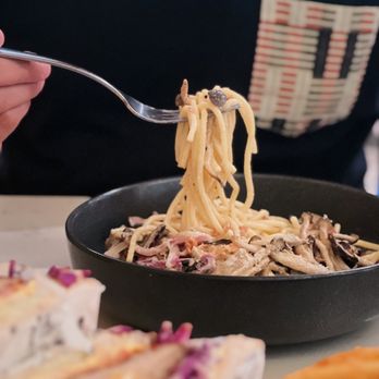 Light Cafe - a person holding a fork over a bowl of pasta - Cafes Near Me - Toronto, Ontario
