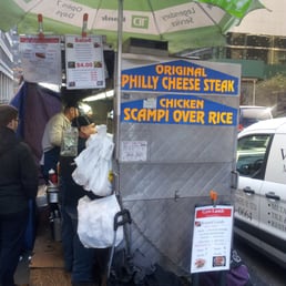 a food cart on a city street a food cart on a city street