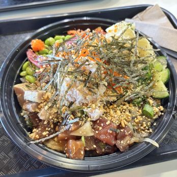 Poke Wave - Build Your Own Bowl - Large - A large poke bowl contains fresh vegetables, sliced fish, and toppings like seaweed, sesame seeds, and chopped nuts, served on a black tray. - Poke Near Me - Tempe, Arizona