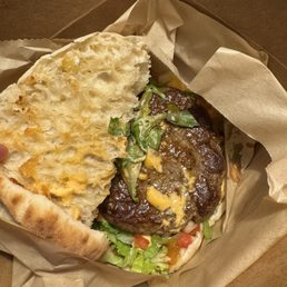 Lamb burger - tomato jam, harissa mayonnaise, pickled vegetables and shredded romaine lettuce.