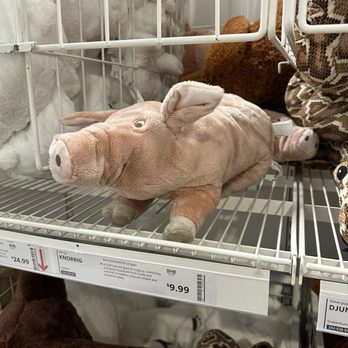 IKEA - Stuff piggy - A soft plush pig toy with a realistic pig face and ears is placed on a store shelf, surrounded by other stuffed animals and toys. - Home Decor Near Me - Schaumburg, Illinois