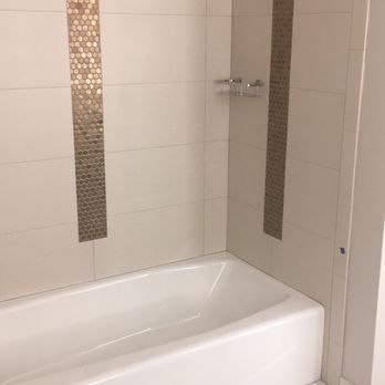 Eric Ross Tile - a bathtub and shower in a bathroom - General Contractors Near Me - Redding, California