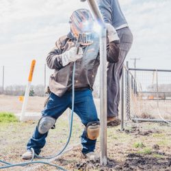 Texas Select Fencing - West Texas - Your Texas Select Fencing crew building a 5' Top Rail Pipe Fence with No Climb Wire