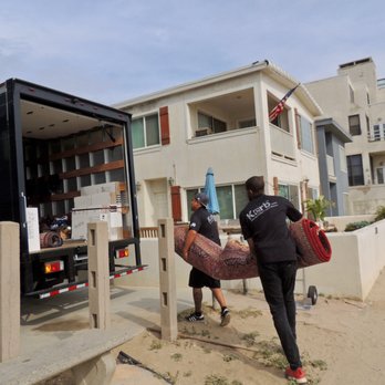 Kerb Pittsburgh Movers - Carrying a rug - Movers Near Me