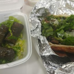 Lamb gyro and grape leaves with accompanying sauces!