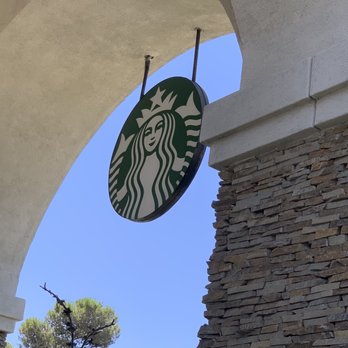 Starbucks - a starbucks sign hanging from the side of a building - Coffee & Tea Near Me - San Marcos, California