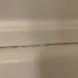 Ronin Plumbing And Mechanical - The horrible caulking job...was told that he would charge me to come back and fix. The entire tub was never secured properly. AWFUL SERVICE