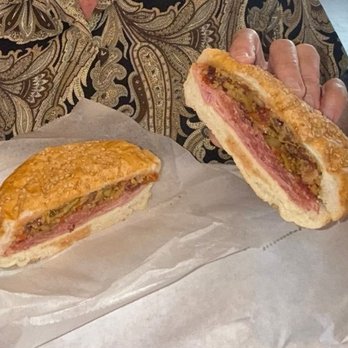 Blues City Deli - MUFFULETTA Genoa Salami, Ham, Mortadella and Provolone, Topped with EVOO and Homemade Olive Salad. This is the single portion. - Sandwiches Near Me - St Louis, Missouri