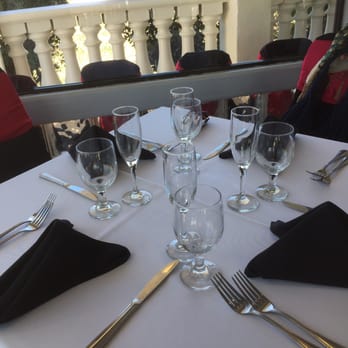 Coco Palm Restaurant - Nice white linen set up with floor to ceiling glass panels. - Cuban Near Me - Pomona, California