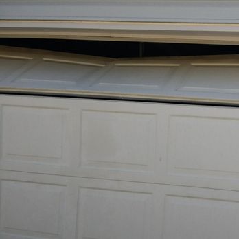 After Hours Garage Door - This top section is damaged because of an improperly mounted opener rail - Garage Door Services Near Me - Aurora, Colorado After Hours Garage Door - This top section is damaged because of an improperly mounted opener rail - Garage Door Services Near Me - Aurora, Colorado