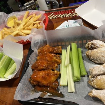 Crockett's Lodge - a tray of chicken wings, celery sticks, and french fries - New American Near Me - Morgantown, West Virginia Crockett's Lodge - a tray of chicken wings, celery sticks, and french fries - New American Near Me - Morgantown, West Virginia