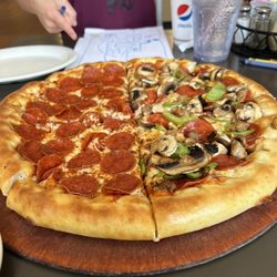 Pizza Hut - Stuffed crust half pepperoni, half supreme no onions extra mushrooms.