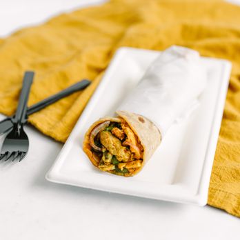 Kati Roll Wala - a plate of food and utensils - Indian Near Me - Houston, Texas Kati Roll Wala - a plate of food and utensils - Indian Near Me - Houston, Texas
