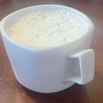 The Victory - a cup of milk on a table - Coffee & Tea Near Me - Madison, Wisconsin