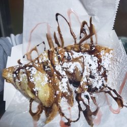Asian Street Cravings - Cheesecake Wontons:cheesecake filling in crispy wonton skin, drizzles of chocolate & special strawberry sauce, and then hit w/powder sugar!