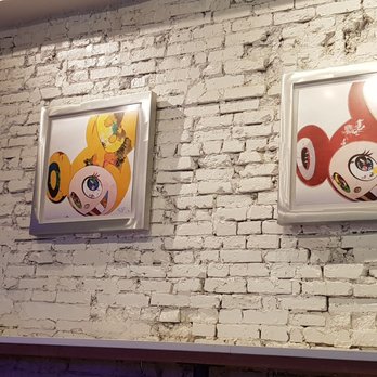 Ruckus - a brick wall with paintings on it - Ramen Near Me - Boston, Massachusetts