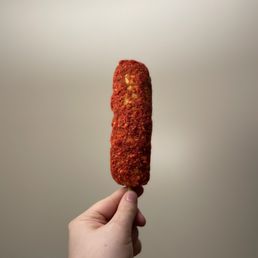 a hand holding a piece of food