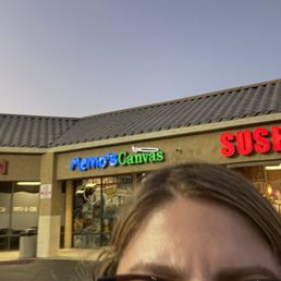 It is next to a sushi restaurant and a smoke store
