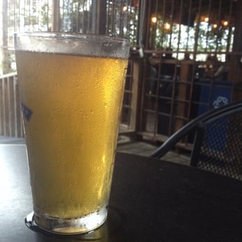 The Grackle - Beer on patio on table. - Dive Bars Near Me - Austin, Texas The Grackle - Beer on patio on table. - Dive Bars Near Me - Austin, Texas