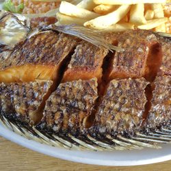 Fish is scored (cut open) for easy eating.