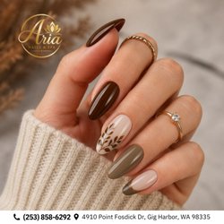 Aria Nails & Spa - Cozy autumn botanicals! High-gloss almond nails pair rich espresso with soft olive French arches and delicate painted branches. Book now!