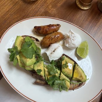Granger & Co - classic section - toasted dusty knuckle sourdough, avocado, lime and coriander + poached egg - Juice Bars & Smoothies Near Me - London, XGL Granger & Co - classic section - toasted dusty knuckle sourdough, avocado, lime and coriander + poached egg - Juice Bars & Smoothies Near Me - London, XGL