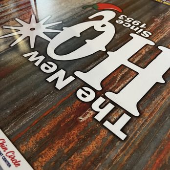 Headquarters Cafe - Table - A wooden table features a colorful logo with a chili pepper and text, indicating a restaurant or food establishment. - American Near Me - Maricopa, Arizona