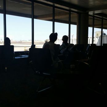 Delta Air Lines - Too dark, but it's a photo of older man reading, and you lady on her cell!! The generation gap - Airlines Near Me - Phoenix, Arizona