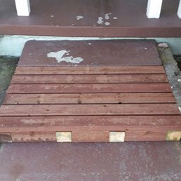 Looking at front of the stairs. The wood decking extends the concrete step making it easier to use with a walker Looking at front of the stairs. The wood decking extends the concrete step making it easier to use with a walker