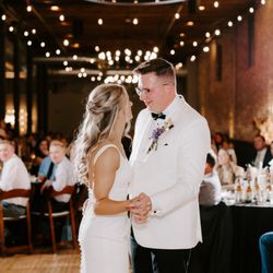 Mercantile Hall - A couple sharing a timeless first dance under the romantic main hall lights.