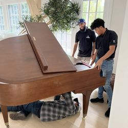 A to B Movers - Setting up a Baby Grand Piano after moving it