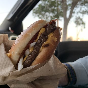 McDonald's - a person holding a hamburger in their hand - Burgers Near Me - Nipomo, California