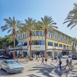 Shoppers cross the street outside the Vuori storefront at Kierland Commons.